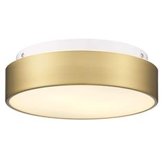 a round light fixture with a gold finish