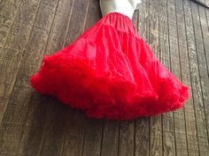 26" long full nylon petticoat in good vintage condition. Labeled size medium to large. Waist stretches from 22" to 38" around. Feel free to msg me with any questions. Red Stretch Skirt For Costume Party, Summer Skirt With Attached Cancan In Red, Red Summer Skirt With Attached Cancan, Summer Red Skirt With Attached Cancan, Red Ruffled Skirt For Costume Party, Stretch Petticoat With Ruffles For Dance, Red Fitted Petticoat For Party, Fitted Red Petticoat For Spring, Dance Petticoat With Ruffles And Stretch