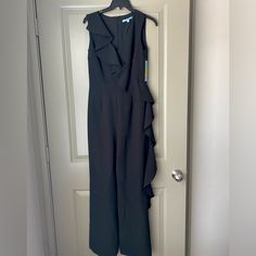 Women’s Antonio Melani Eva Ruffle Front Jumpsuit/Romper In Black Nwt! New With Tags, This Adorable Romper Has Never Been Worn, Has Stayed Inside A Garment Bag Since Purchase, And Comes From A Smoke And Pet-Free Home. It’s The Perfect Outfit For Any Occasion- Date Night, Dinner, Or Evening Wedding Guest. Color: 001 Midnight Waltz Size: Us 2 | Uk 6 | Europe 32 -Crepe Fabrication -V-Neckline -Sleeveless -Ruffle Trim Detail From Shoulder To Opposite Leg -Full Length, Straight Hemline -Invisible Back Formal Black Ruffled Jumpsuits And Rompers, Black Ruffled Jumpsuits And Rompers For Work, Black Workwear Jumpsuits And Rompers With Ruffles, Sleeveless Ruffled Jumpsuits For Formal Occasions, Fitted Ruffle Jumpsuits And Rompers For Work, Formal Sleeveless Ruffled Jumpsuits And Rompers, Fitted Ruffled Jumpsuits And Rompers For Work, Fitted Ruffles Jumpsuits And Rompers For Work, Formal Sleeveless Ruffled Jumpsuit