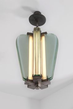 an art deco ceiling light with two lights on each side and one light in the middle