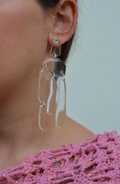 a close up of a person wearing earrings