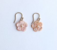 "These earrings are from our Flower Collection. Each piece in this collection features one or more hand-carved genuine stone flowers. Hand-sculpted from pink Mother of Pearl into beautiful floral blooms, the flowers measure 15mm and have white Fresh Water Pearls at their centers.  Earring Length: 1.13\" Closure: S Hook" Delicate Pink Pierced Earrings, Elegant Pink Jewelry With 3d Flowers, Pink Flower Shaped Pierced Earrings, Feminine Flower Jewelry With 3d Flowers, Feminine 3d Flower Jewelry, Delicate Pink Earrings, Petal-shaped Earrings With 3d Flowers As Gift, Feminine Flower-shaped Jewelry With Matching Earrings, Petal-shaped 3d Flower Earrings For Gift