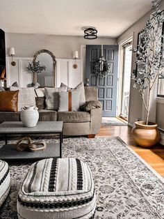 a living room filled with lots of furniture next to a door and window sill