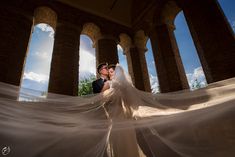 the bride and groom are posing for their wedding photo