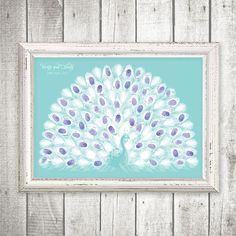 a blue and white peacock print hanging on a wall