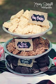 three tiered trays filled with cookies and crackers on top of each other