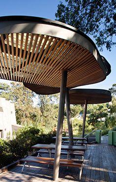 an outdoor seating area with benches and trees