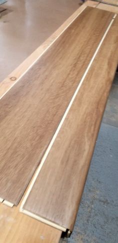 some wood planks laying on top of each other in a room with metal flooring