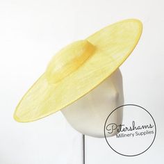 This Yellow cartwheel hat base is a classic shape that has sprung into popularity in the past year. Made from 2 layers of stiffened sinamay, these cartwheels are ready to trim and are fitted with a petersham ribbon on the inside crown edge. Simply add a comb or headband to secure to the head.Hat base measures:Width: 35.5cm (14 inches)Crown Width: 13.5cm (5.3 inches)Crown Height: Approximately 3.5cm (1.7 inches)For even more millinery supplies you can find us here:www.etsy.com/shop/PetershamsAll Fitted Hat With Round Crown For Kentucky Derby, Adjustable Curved Brim Fascinator For Spring, Spring Adjustable Fascinator With Curved Brim, Spring Fascinator With Curved Brim, Spring Mini Hat With Round Crown, Adjustable Curved Brim Boater Hat For Royal Ascot, Adjustable Curved Brim Boater Hat For Church, Spring Adjustable Fascinator With Round Crown, Spring Adjustable Round Crown Fascinator