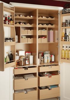 an organized pantry with lots of bottles and containers in the cupboards, as well as other items