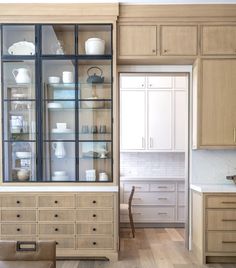 a kitchen filled with lots of wooden cabinets