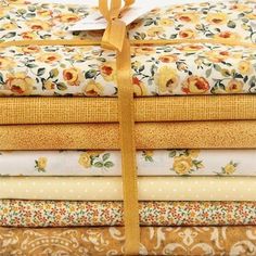 a stack of yellow and white floral fabric