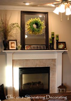 a mantel with a wreath on top of it and other decorations around the fireplace