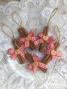 cinnamon stick ornaments are arranged on a lace doily