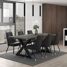 a dining room table with black chairs next to a window