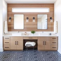 a large bathroom with two sinks and mirrors