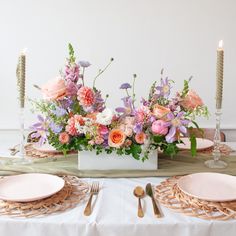 An orange, peach, pink, purple, lavender, chartreuse and white long & low flower centerpiece sits on an event table with pink plate, gold cutlery, woven plate chargers, and tall candlesticks. The floral arrangement includes roses, dahlias, clematis, peonies, allium, snapdragon, queen anne's lace, delphinium, and lisianthus. The vibe is sweet, romantic, and dreamy. Romantic Wedding Colors, Unique Wedding Flowers, Wedding Floral Centerpieces, Wedding Centerpieces Diy, Flower Centerpieces Wedding, Martha Stewart Weddings, Diy Centerpieces, Wedding Table Centerpieces, Floral Centerpieces