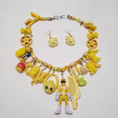 I collect toys as an adult, and I also have the desire to make art with them. This is a carefully curated collection of small toys that I've made into a chunky charm necklace.  Toys from vintage to modern are featured on here. The theme of this one is yellow. This is a fairly heavy necklace because of all the goodies on it. Perfect if you love vintage and kawaii. Handmade Yellow Novelty Jewelry, Yellow Handmade Novelty Jewelry, Handmade Themed Collectible Jewelry, Quirky Handmade Resin Jewelry, Retro Charm Necklaces For Gifts, Handmade Retro Resin Jewelry, Handmade Vintage Resin Jewelry, Unique Resin Necklaces For Collectors, Quirky Yellow Jewelry For Gift