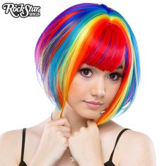 This dramatic, wedge-shaped bob is a popular style among fashionistas! Short in the back and long in the front, it comes with longer bangs, leaving you with endless styling opportunities!   Model: Mynx Midnight Can take heat up to 360 degrees Adjustable Weft Unisex Washable Langer Pony, Rainbow Wig, Rainbow Hair Color, Rainbow Rocks, Wig Party, Halloween Costume Shop, Long Bangs, Short Bob Wigs, Bob Wig