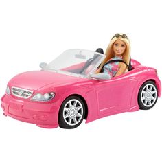 a barbie doll in a pink sports car