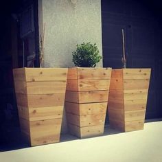 three wooden planters sitting next to each other