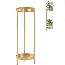 two gold plant stands next to each other with plants hanging from the top and bottom