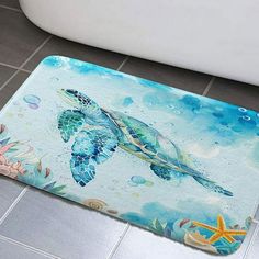 a bathroom rug with a sea turtle and starfish on the floor next to a bathtub