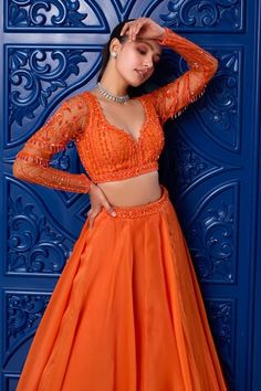 Orange attached cancan lehenga with embroidered waistband. Paired with sequin, glass bead, stone, cutdana embroidered padded blouse and dupatta. - Aza Fashions Fitted Hand Embellished Dress For Navratri, Fitted Hand Embellished Lehenga For Diwali, Festive Fitted Hand Embellished Choli, Fitted Hand Embellished Lehenga For Navratri, Navratri Fitted Hand Embellished Choli, Fitted Hand Embellished Organza Lehenga, Hand Embellished Fitted Organza Lehenga, Fitted Hand Embellished Sets For Navratri, Hand Embellished Fitted Organza Choli