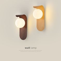 two wall lamps made out of wood and white lights on the side of each lamp