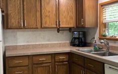 a kitchen with wooden cabinets and white appliances