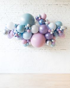 a bunch of balloons are hanging on the wall