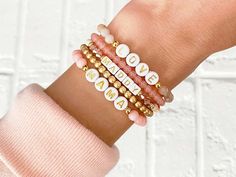 Personalized Word Bracelet Pink Custom Beaded Bracelet - Etsy Round Bead Bracelet Ideas, Word Bracelet Beads Ideas, Bracelet Packaging Ideas Diy, Easter Bracelets, Name Bracelet Gold, Homemade Bracelets, Bff Bracelets, Multiple Bracelets, Bracelet Stacking