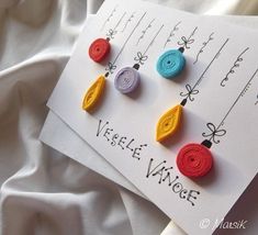 three different colored crochet earrings on top of a piece of paper with writing