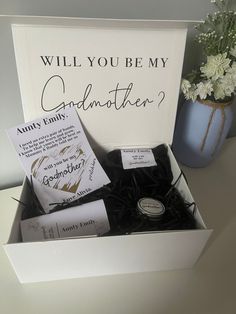 an open box with some cards in it on a table next to a potted plant