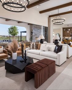 a living room filled with furniture and a large window covered in light fixturees above it