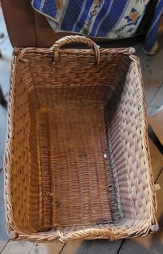 a wicker basket sitting on top of a wooden floor