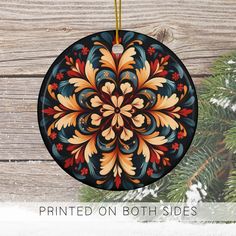 a christmas ornament hanging on a wooden wall with snow and pine branches in the background