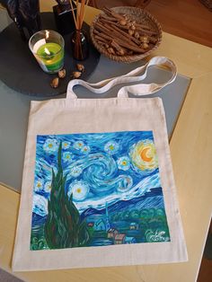 "100% handmade bag  100% handpainted  Van Gogh Women Canvas Tote Bag, The Starry Night Shoulder Bag Gift For Women, Impressionism Shopping Tote Bag Gift for Mom. Measuring at 16\"h x 14\"w (40cm x 35cm ) and with a handle length of 25.5\" (65 cm), these tote bags are with 100% linen canvas fabric. The bag has reinforced handle stitching for durability.  100% handmade bag  100% handpainted  Material: 100% natural linen canvas fabric  One size - 16\"h x 14\"w (40cm x 35cm)  Handle length - 25.5\" (65 cm)  Care Instructions:  Hand painted with special paint for textiles.  For the best preservation of the paint wash by hand.  You can machine wash separately: cold (max 30C or 90F), gentle cycle;  Tumble dry: low heat;  Do not iron directly over the painted area, it may stick to the iron.  Color Artistic Hand Painted Shoulder Bag For Gift, Artistic Hand Painted Shoulder Bag Gift, Artsy Handmade Canvas Bag Perfect For Gifts, Artsy Handmade Canvas Bag For Gift, Artistic Shoulder Bag With Artwork For Gifts, Handpainted Tote, Handpainted Tote Bags, Paint Wash, Painted Vans