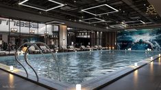 a large indoor swimming pool with lights on the ceiling and chairs in the back ground