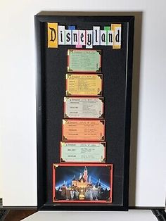 the disneyland ticket collection is displayed in front of a computer keyboard and mouse on a desk