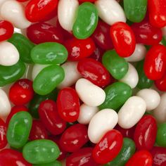 many different colored candies are in a pile on top of each other with white and green ones