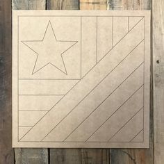 a piece of paper with a star cut out in it on top of wood planks