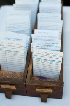 several wooden boxes filled with papers on top of a table