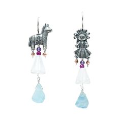 These earrings feature a unique and playful design, with a Silver Mexican Burrito Pinata charm on one side and a Muñeca Maria silver charm on the other, reflecting the art of Artesanias Mexicanas and Mexican Folk Art. The charms are beautifully embellished with aquamarina gems, adding a touch of elegance and sparkle to these Pendientes Plata. Each charm measures 1 inch in size, creating a balanced and eye-catching look that symbolizes the craftsmanship of Joyeria Plata. The earrings themselves h Whimsical Sterling Silver Charms Jewelry, Whimsical Sterling Silver Jewelry With Matching Earrings, Whimsical Sterling Silver Dangle Earrings, Whimsical Sterling Silver Earrings, Artisan Dangle Charms Jewelry, Whimsical Sterling Silver Drop Earrings, Whimsical Sterling Silver Pierced Earrings, Whimsical Drop Earrings With Dangling Charms, Artisan Sterling Silver Earrings