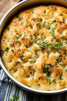 a casserole dish with cheese and herbs