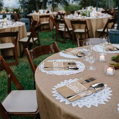 the tables are set with silverware and place settings for an outdoor wedding reception at dusk