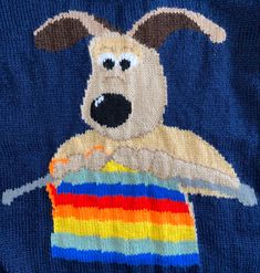 a sweater with a dog holding a rainbow flag on it's chest and eyes