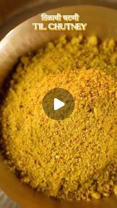 a bowl filled with yellow powder on top of a wooden table