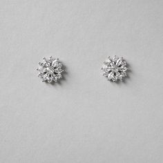 Bright CZ flower earrings for the bride or bridesmaids. Add a floral touch to your wedding day look with these beauties! They are .5 inches long and made with AAA CZ stones set in rhodium silver plating which makes them lead, nickel, and cadmium free. Bridal Flower, Flower Stud Earrings, Flower Stud, Affordable Jewelry, Flower Earrings Studs, Bridal Flowers, Flower Studs, Cz Stone, Stone Settings