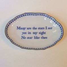 a blue and white plate with words written on the side that says, many are the stars i see yet in my sight no star like thee